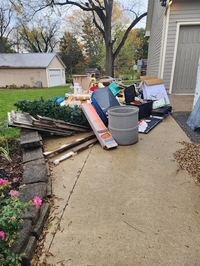 Dumpster being loaded with debris for Estate Cleanout Dumpster Rental in Littlestown